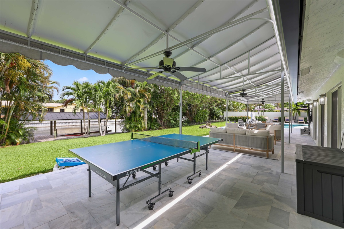 Play ping-pong, relax on the covered patio, or wander toward the canal and pool from this easy outdoor living space.
