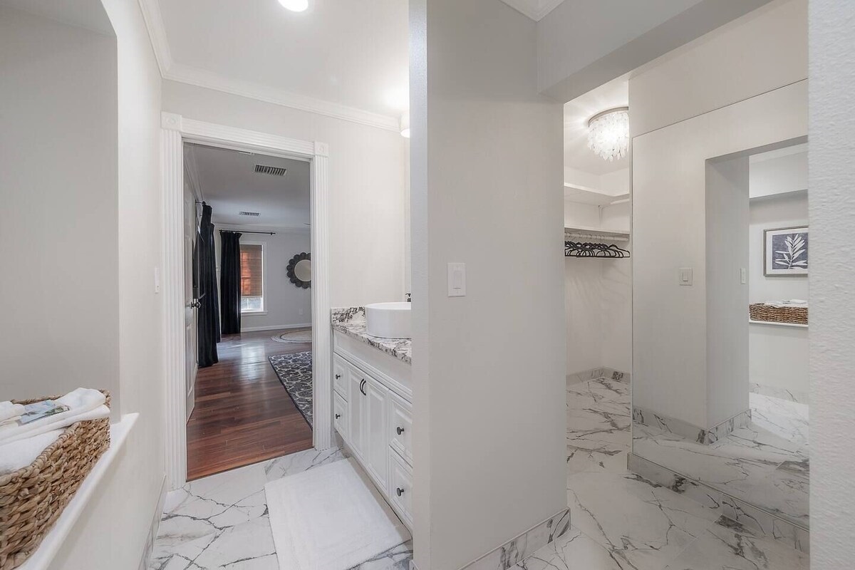 Crisp white finishes and marble-inspired tile offer a clean and luxurious look.