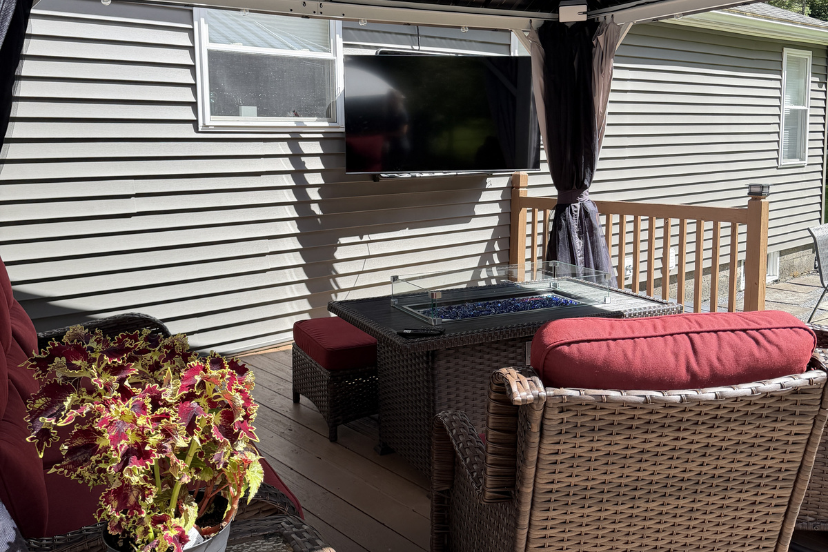 Back porch seating with outdoor SmartTV and gas fire table