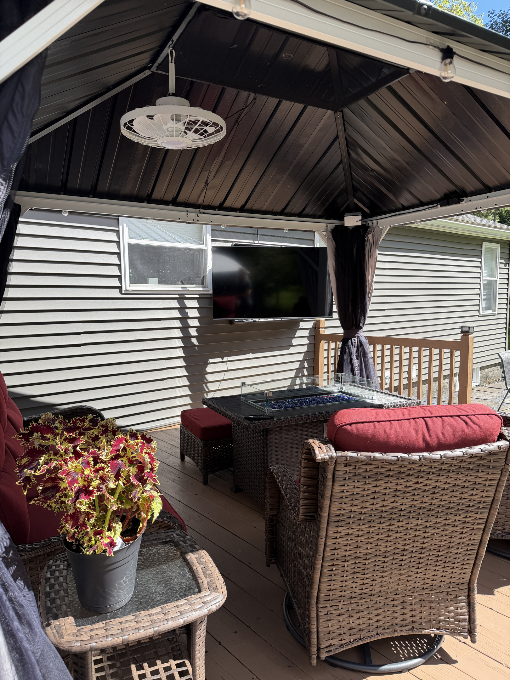 Back porch seating with outdoor SmartTV and gas fire table