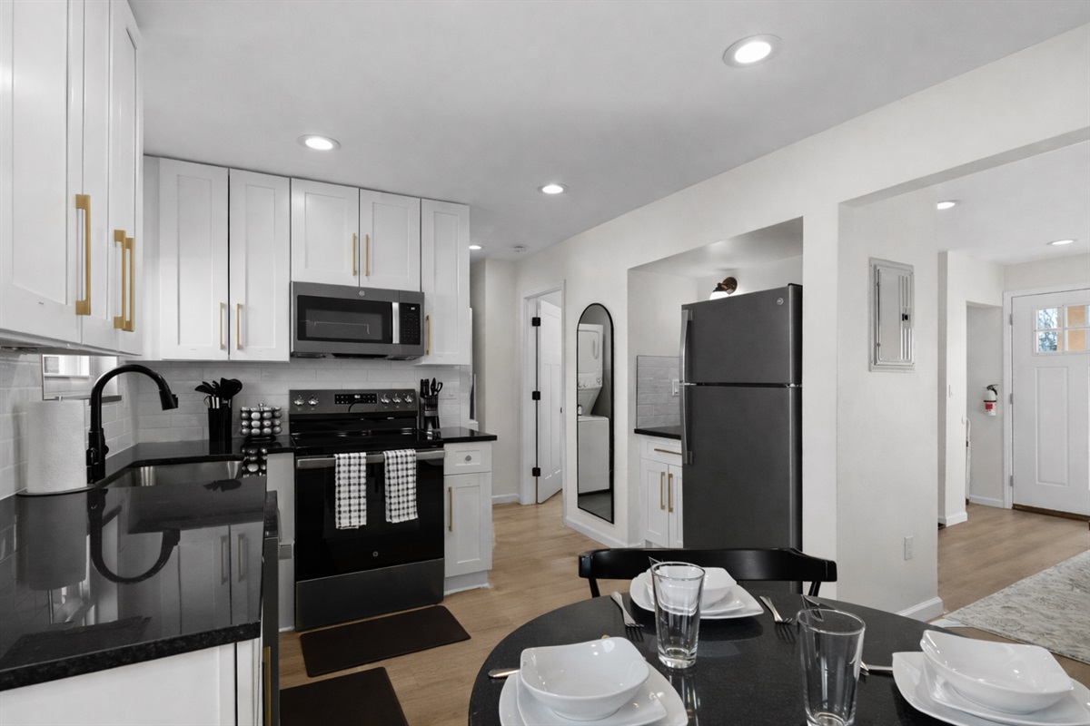 Sleek, modern kitchen with crisp white cabinetry, stainless appliances, and ample counter space—perfect for cooking, hosting, and everyday convenience.