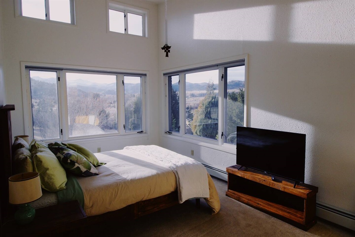  Bedroom adorned with pristine, fresh linens ,Two windows frame breathtaking views of the majestic mountains.