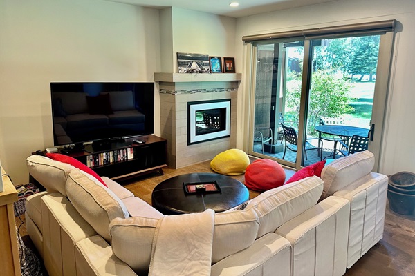 Private patio off the living room has barbecue and dining table/chairs