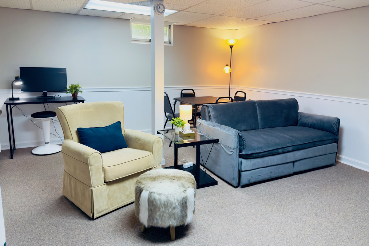 Lower-level game room with comfortable seating and space to spread out.