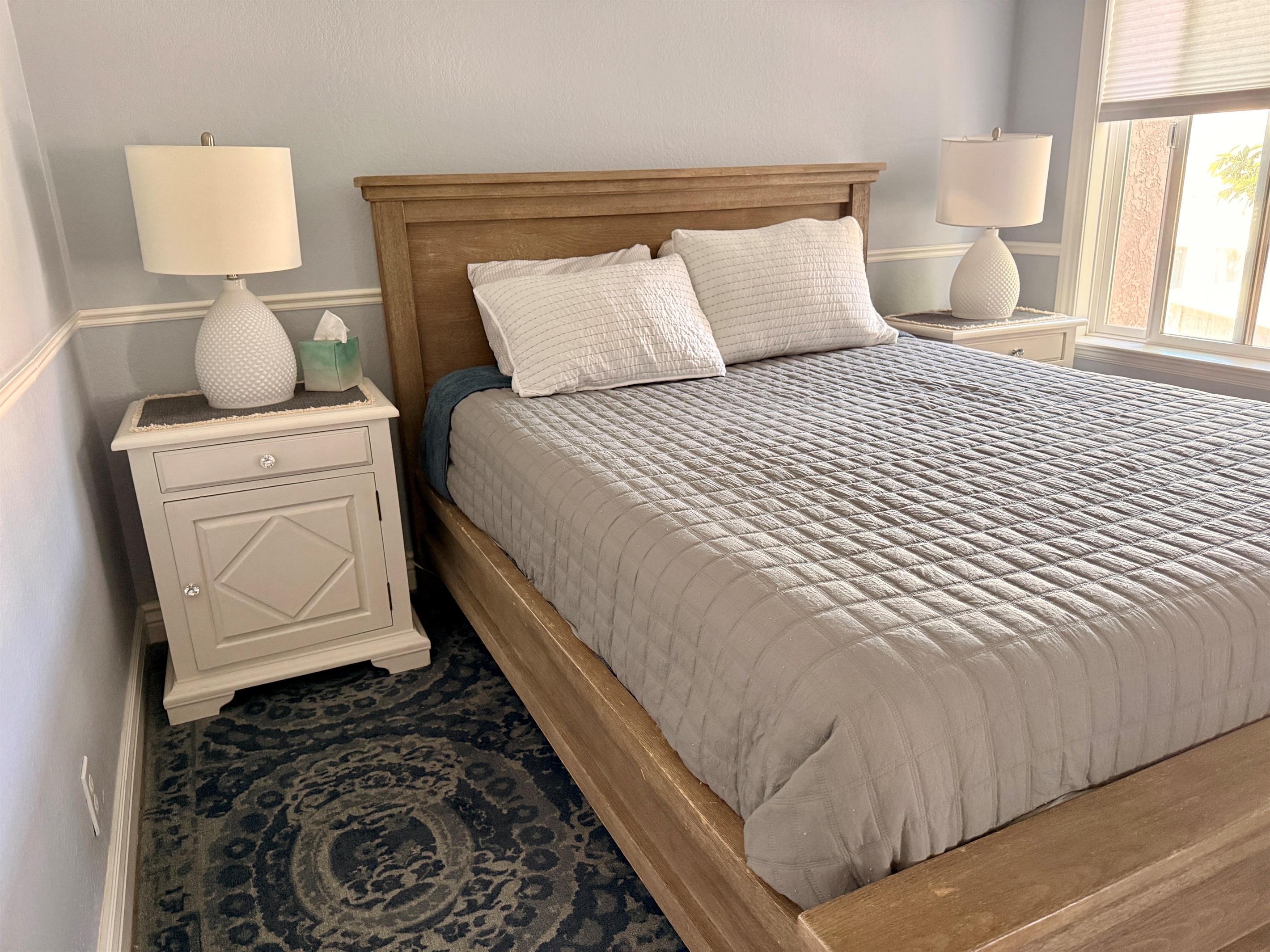 Spare bedroom furnished with a comfy queen sized bed and closet with built-in John Louis Home closet organizer.