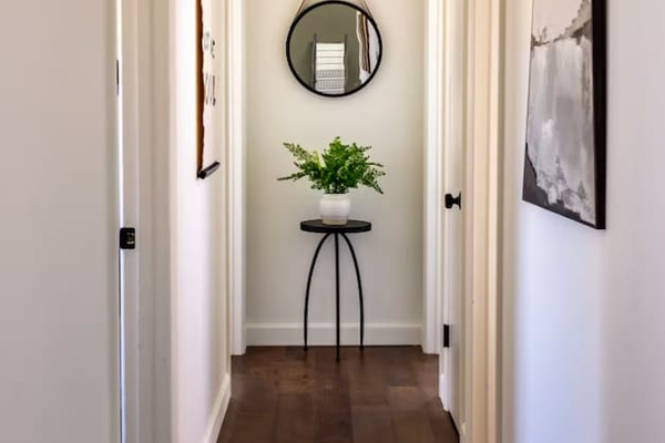A quiet, styled hallway sets the tone the moment you step through the door.