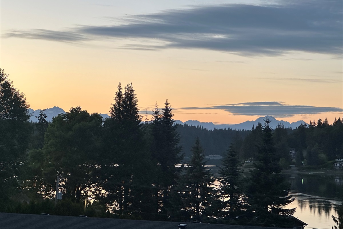 Peace settles over the inlet as mountains stand tall against a fading light