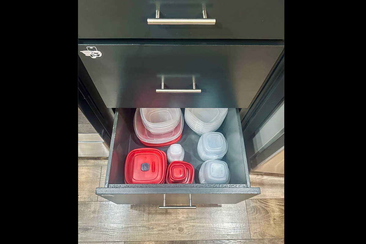 Kitchen drawer organized with a variety of food storage containers to make meal prep and leftovers easy during your stay.