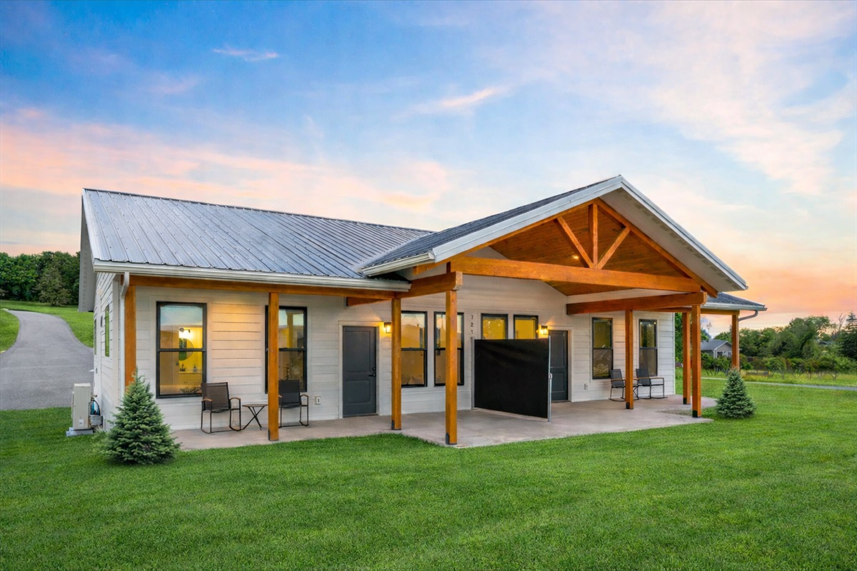 Unjoy Big Sky Country with a relaxing patio with divider for extra privacy. (grass enhanced w/ AI)