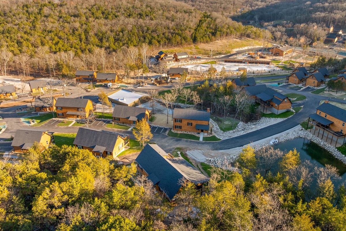A broader view of the cabin community set among the hills.