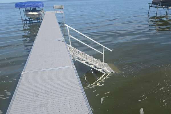 Private dock over 100 feet with bench on "patio" at end of dock and stairs into water