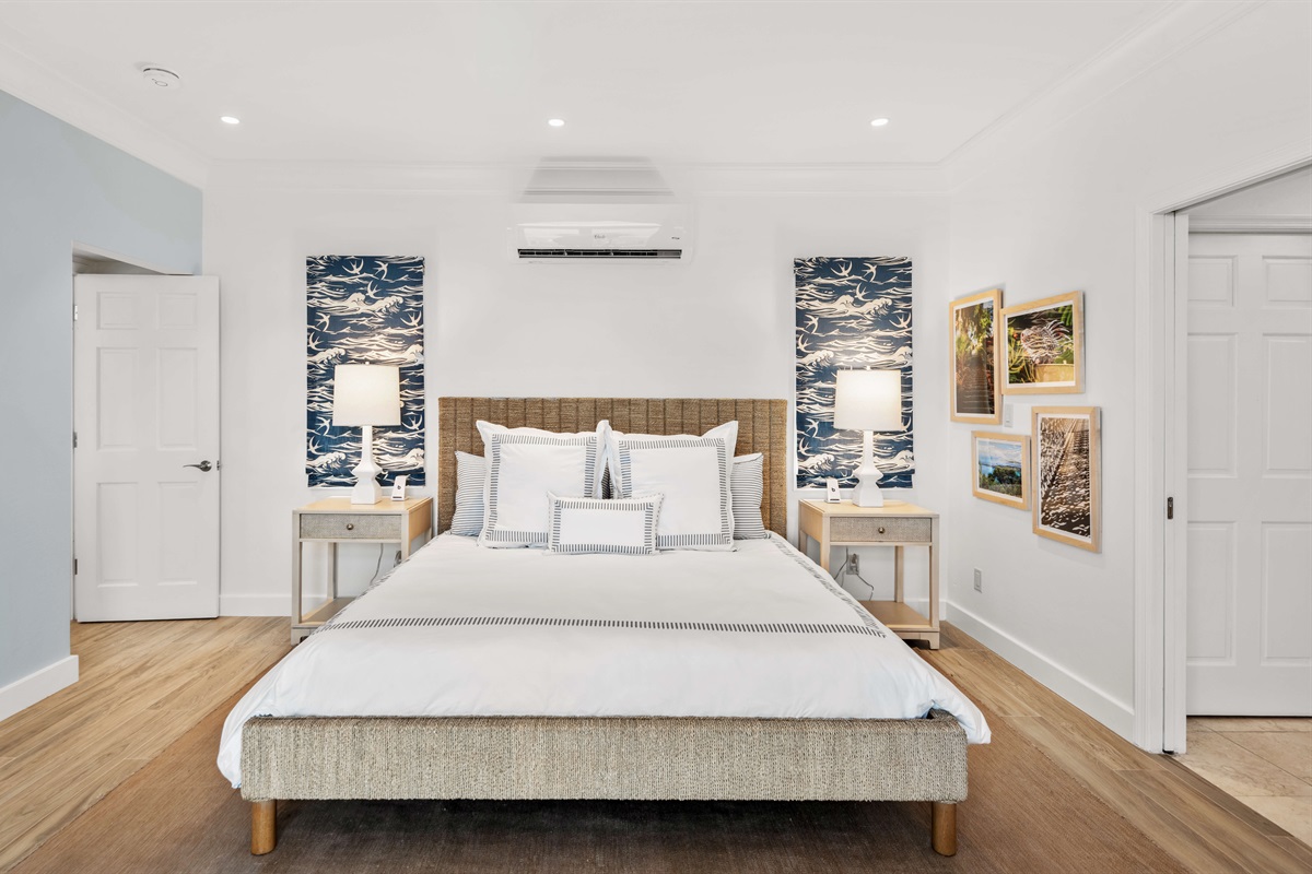 Primary suite with AC, king bed, en-suite bath, large windows, and ocean views. Ideal for privacy and relaxation.