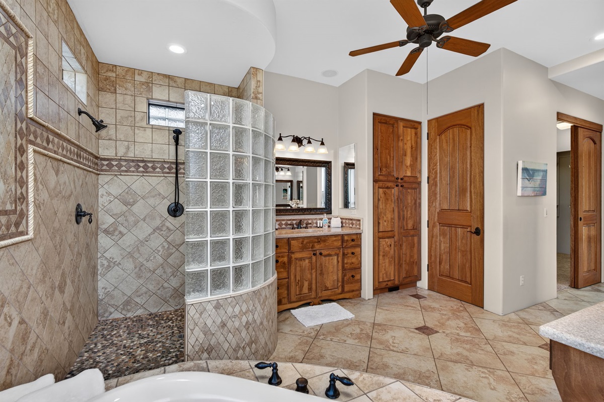 Walk-in glass-block shower and premium finishes create a relaxing spa-inspired primary bathroom retreat