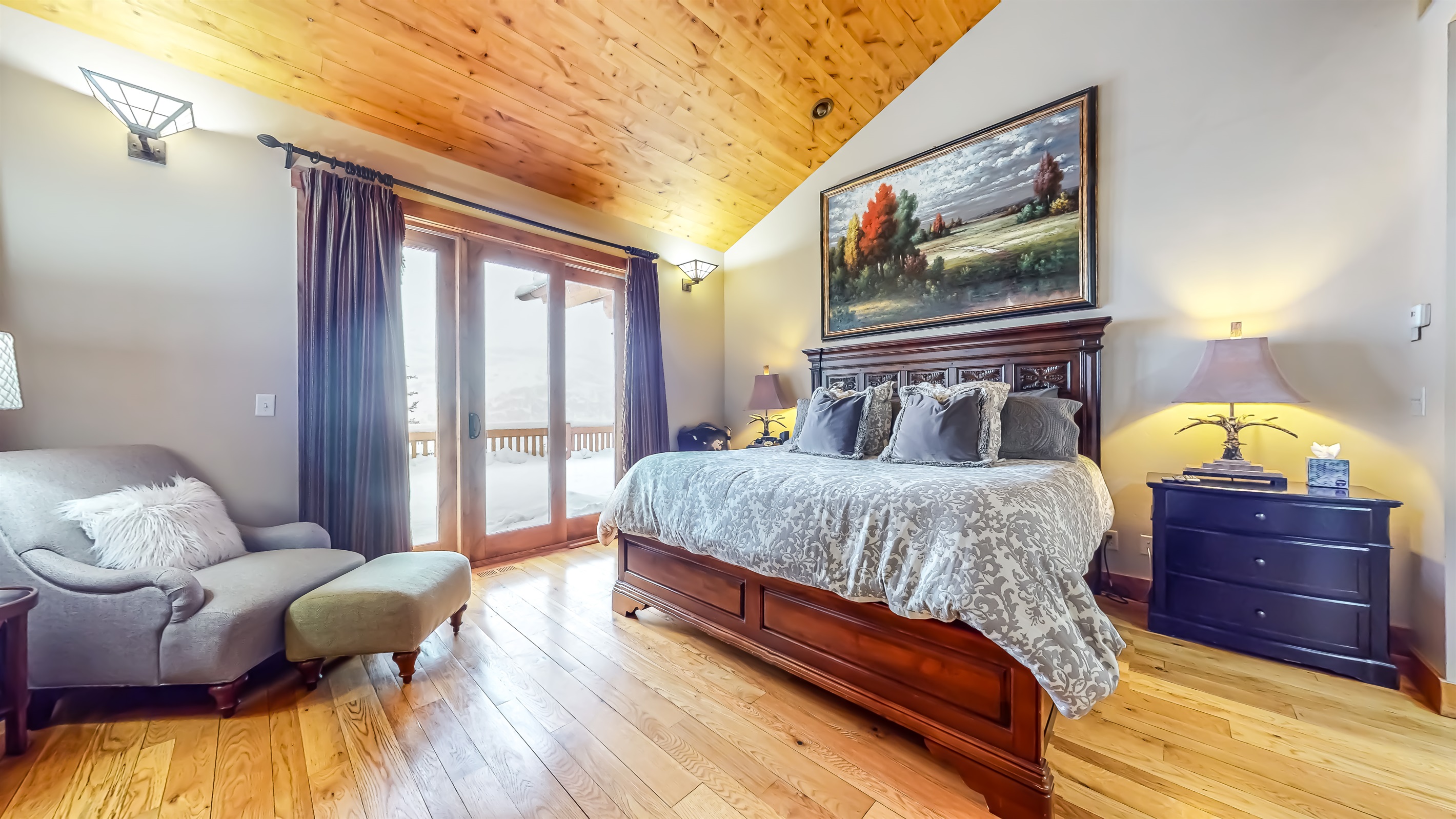 Primary Bedroom with access to balcony. Full walk in closet and gas fireplace for cozy evenings
