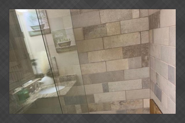 The bathroom features a 24-inch accessible entry and is equipped with a wall-mounted shower chair for added comfort and convenience.