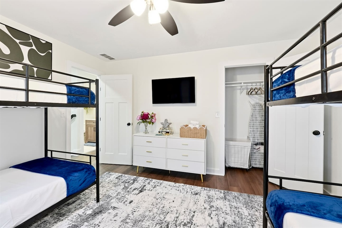 Cozy second-level bedroom with two bunk beds, each with blankets and a Roku TV. First room you see at the top of the stairs. Includes 4 full-body towels, 4 washcloths, and 2 hand towels for your stay.