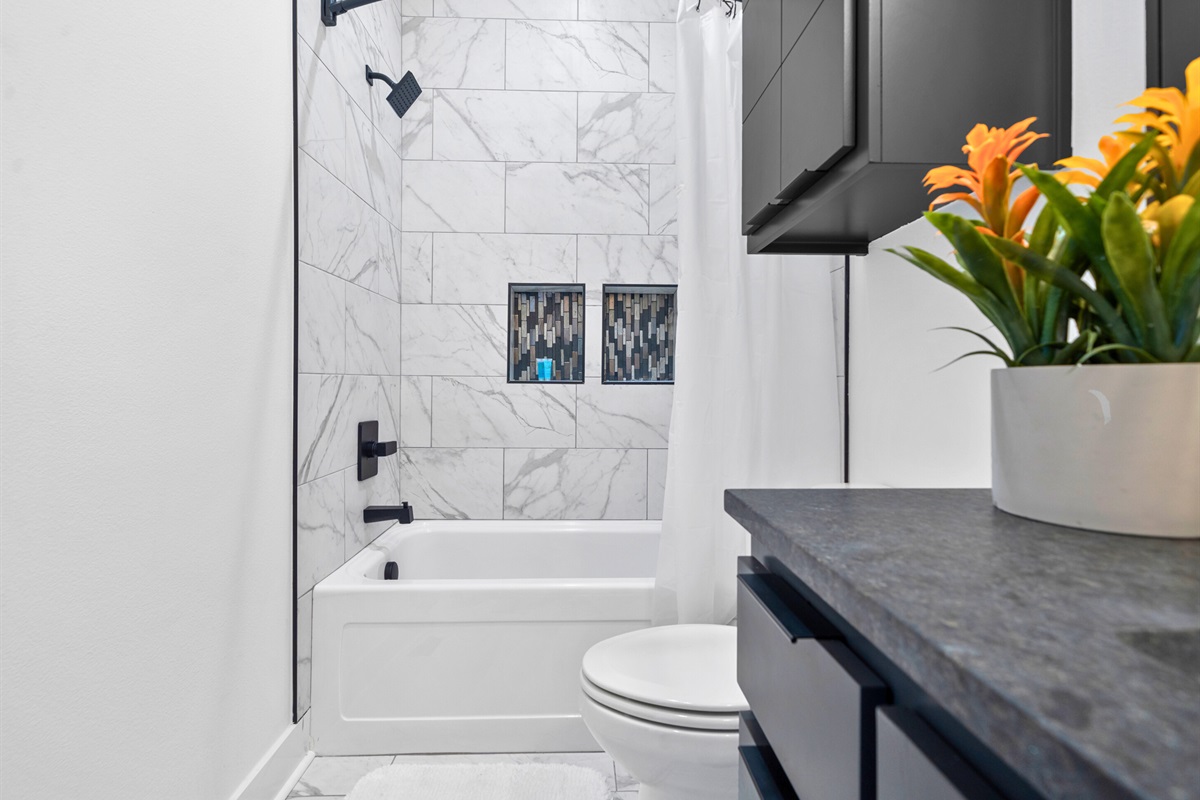 A bright and contemporary bathroom with dual vanities, clean finishes, and an airy layout that balances practicality with sophistication.