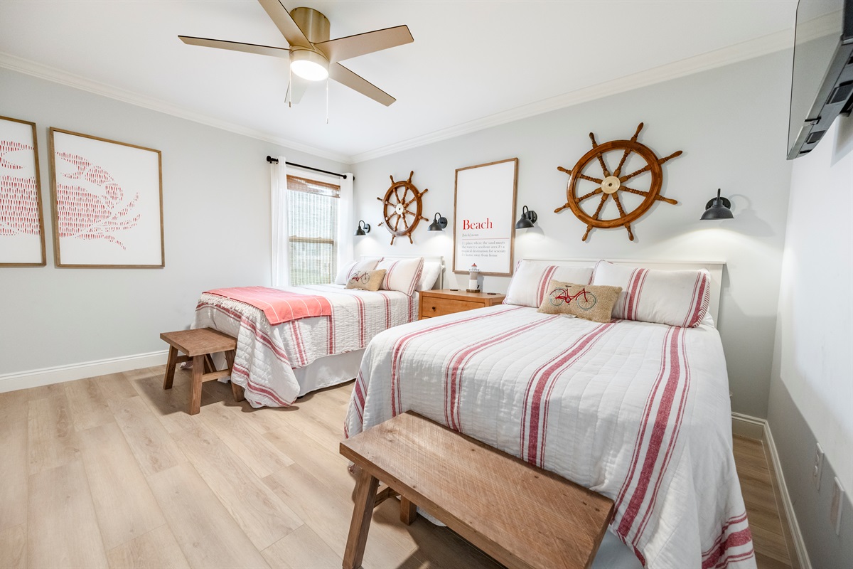 Nautical vibes shine in a cozy twin-bedroom with warm lighting and coastal decor.