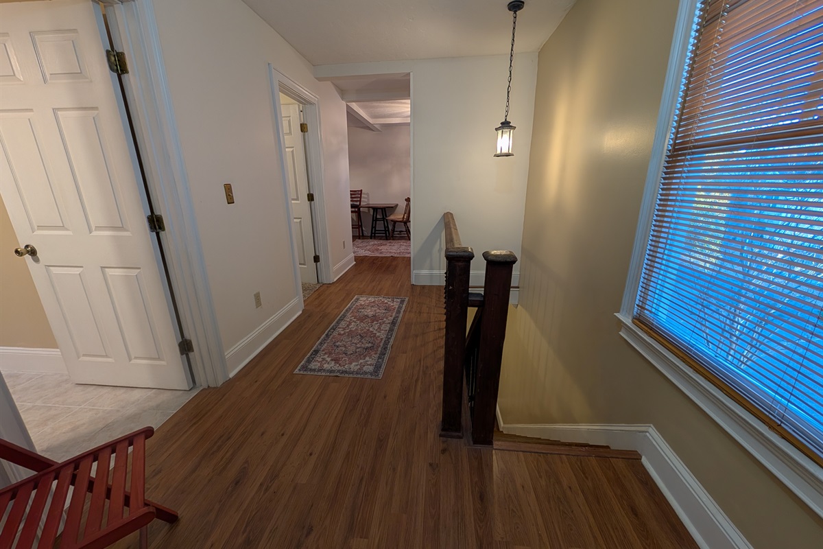 Rear staircase and hallway to upstairs guest bedrooms and bar