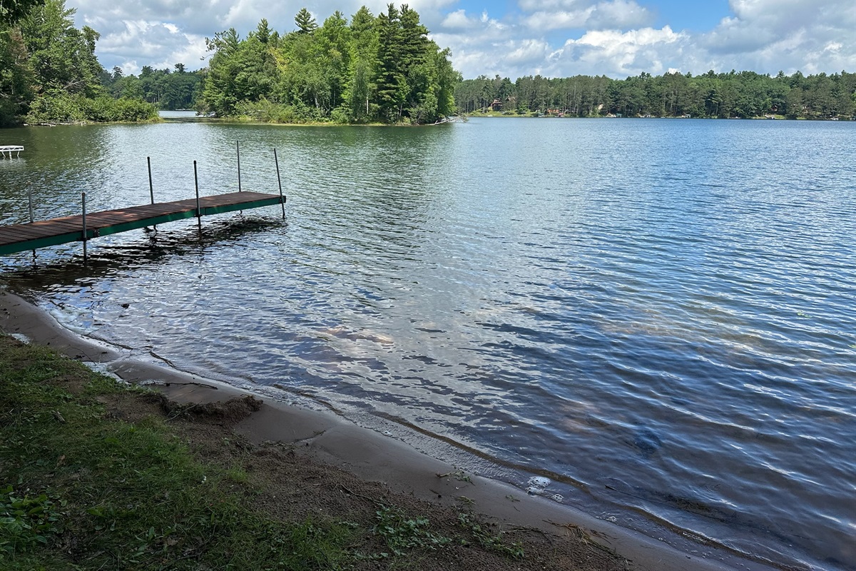 The gentle sandy shoreline is perfect for kids to play or adults to grab a chair and sit with your toes in the water. Bring your boat and park at the private dock.