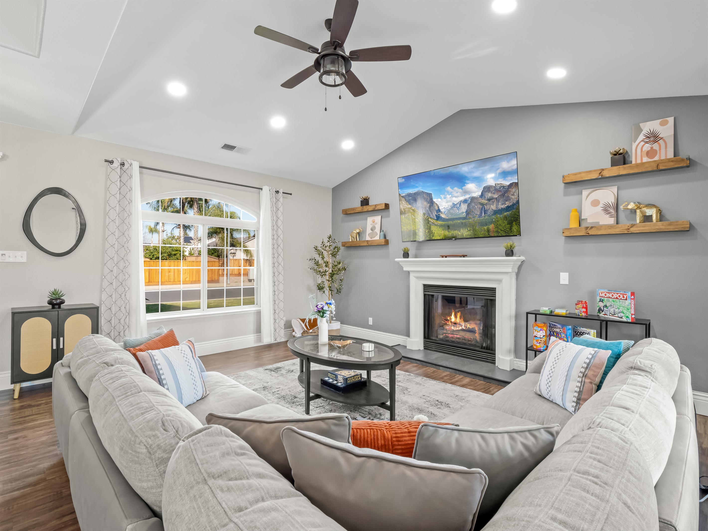 Cozy gathering space with a warm fireplace, large smart TV, and oversized sectional—plus board games for fun family nights in.