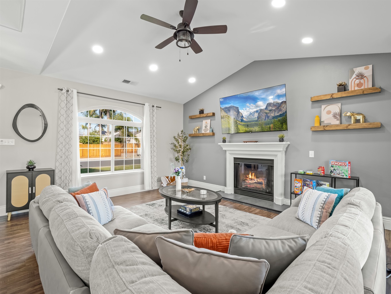 Cozy gathering space with a warm fireplace, large smart TV, and oversized sectional—plus board games for fun family nights in.