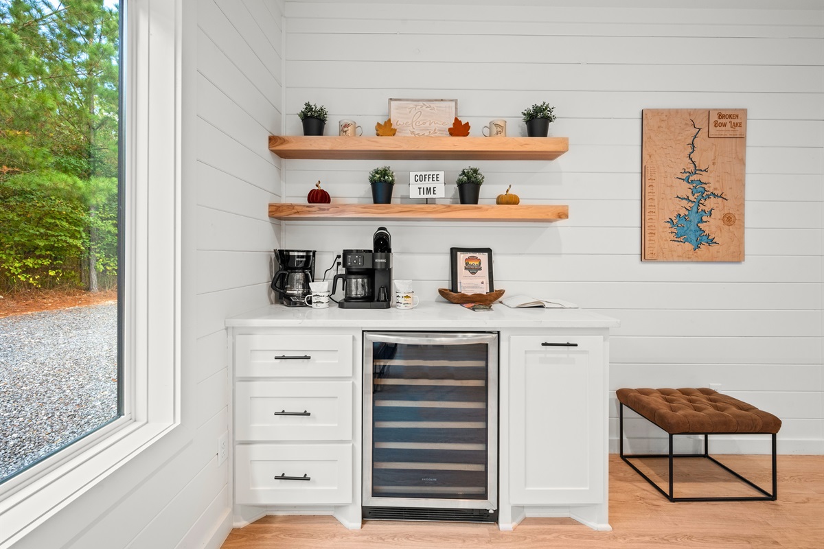 Coffee and wine bar with forest views and open shelving.