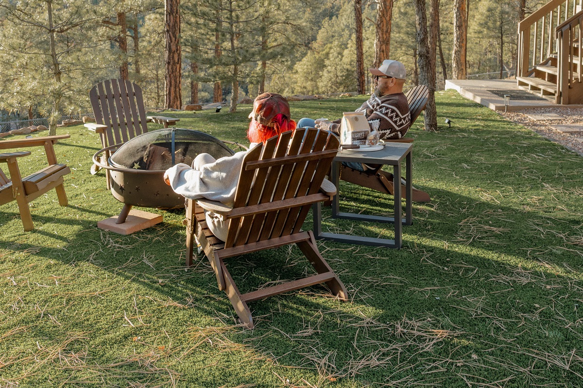 Gather around the fire pit at Poppywood Pines surrounded by towering ponderosa pines. This pet-friendly Show Low cabin offers spacious outdoor space with Adirondack chairs, perfect for s'mores and stargazing after exploring White Mountains hiking and fishi