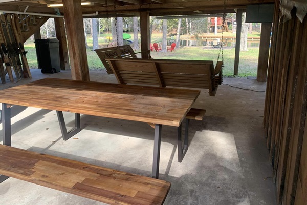 Downstairs deck with dining table and swings.