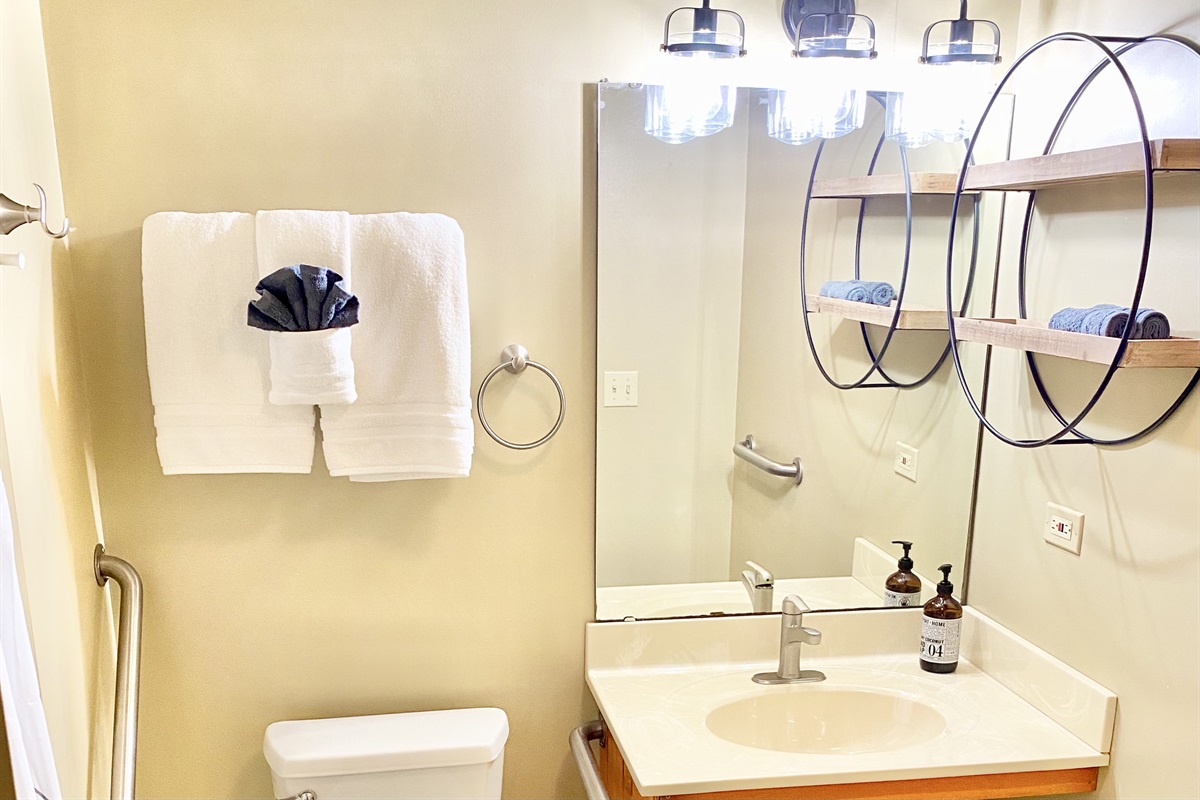Full bathroom with towels, shower, soaps, etc.