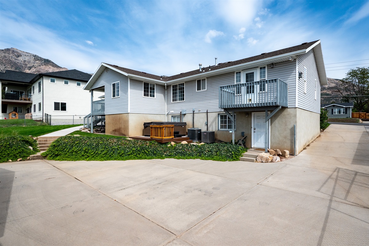 Private hot tub located behind the home with easy access from both the main level and studio entrance.