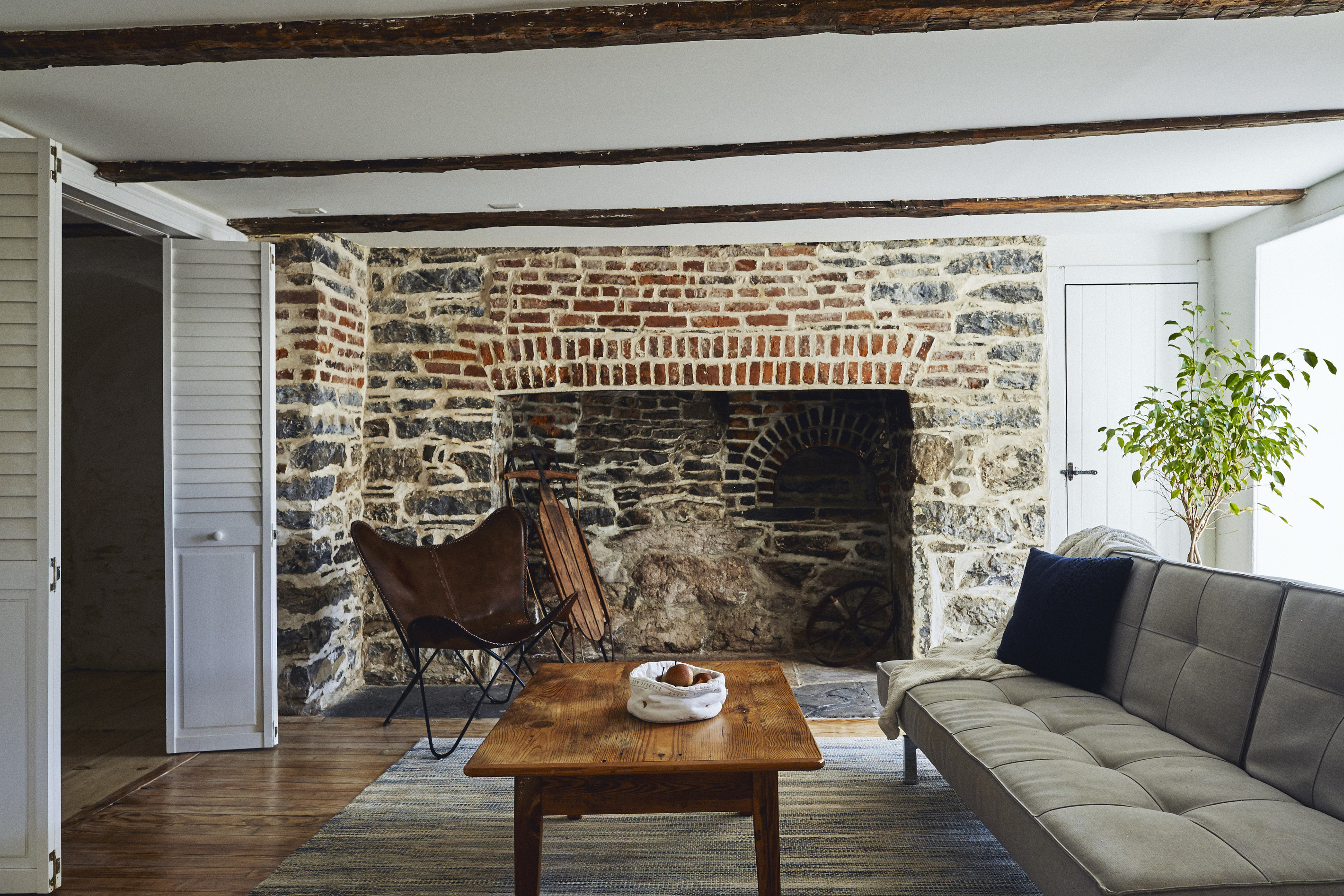 Cozy living room with original colonial (non-working) fireplace including a bread oven.