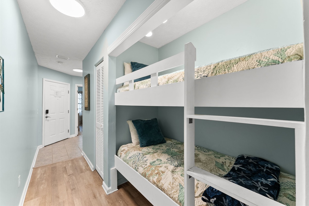 Hallway twin bunk beds — perfect for kids or extra guests, with easy bathroom access.