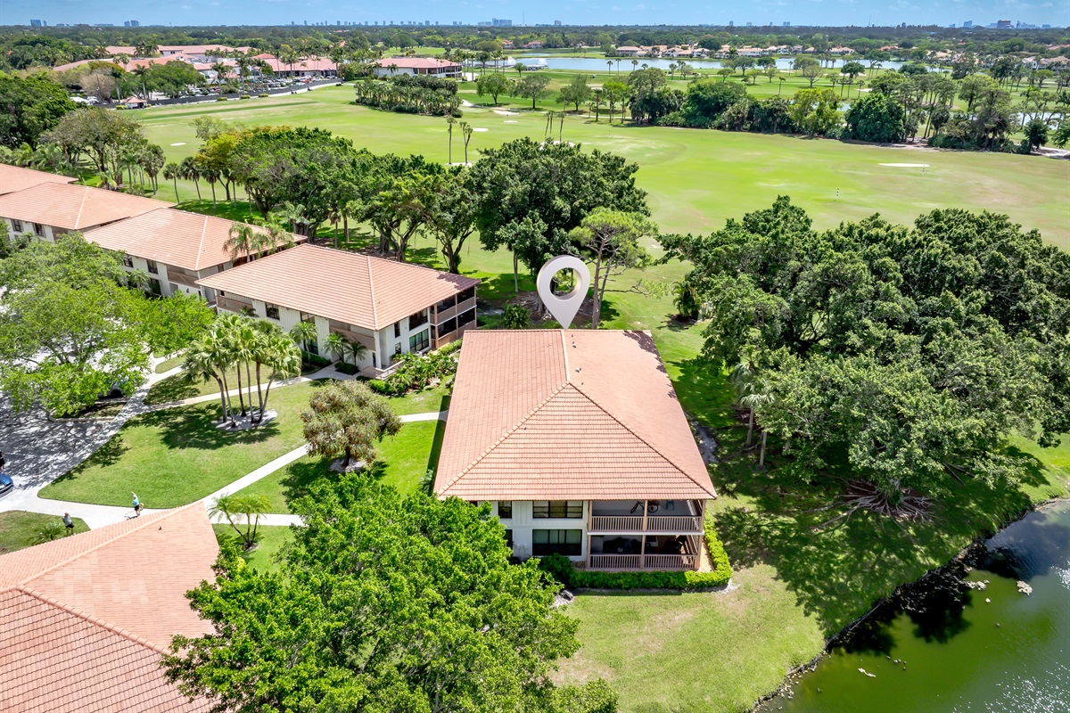 Aerial view showcasing lush golf course, water features, and serene surroundings