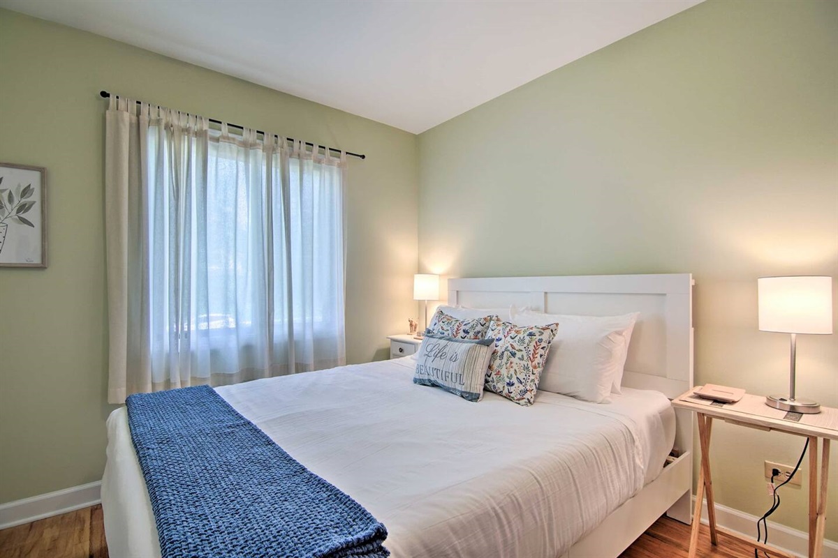 The third upstairs bedroom has a queen sized bed, window AC, and ceiling fan for your relaxation and comfort. 