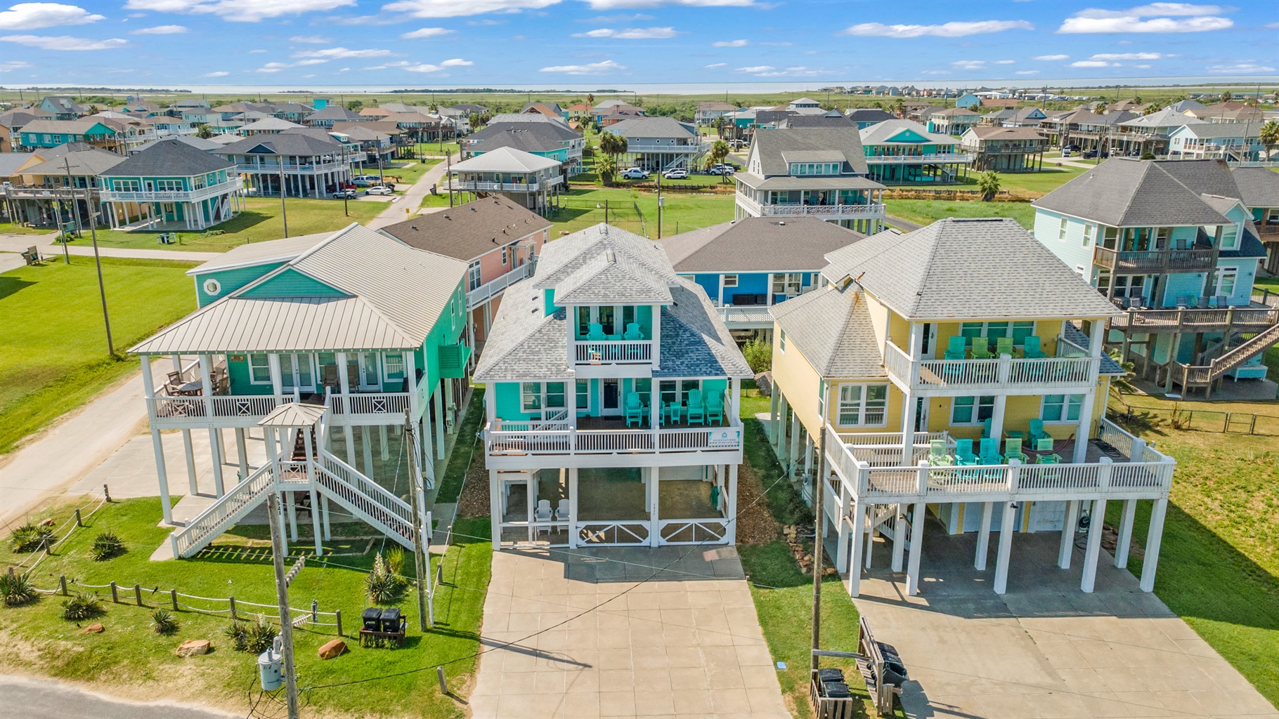 Sandy Toes: From the air: Our turquoise beach house with balconies and a prime beachside location.