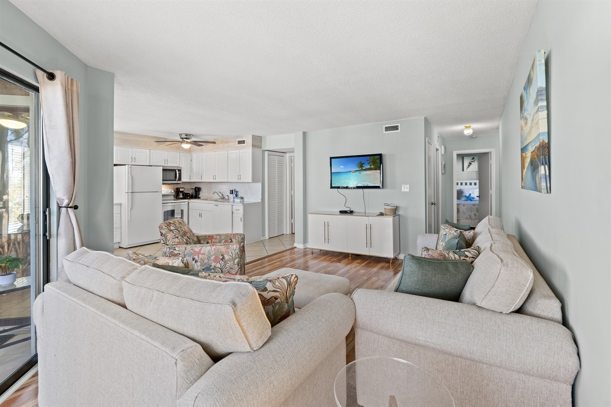 Living Room area with large TV and patio access