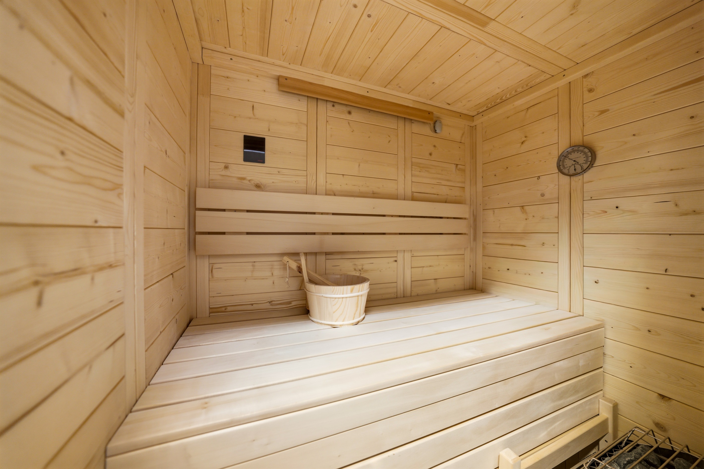 The basement offers an unexpected luxury lounge—featuring a built-in sauna.