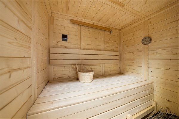 The basement offers an unexpected luxury lounge—featuring a built-in sauna.