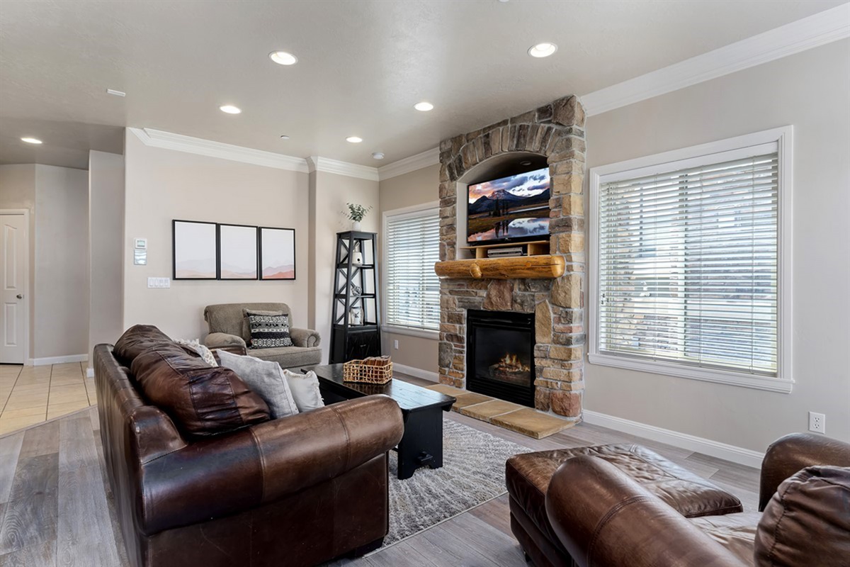 Warm and inviting living space with a cozy fireplace, plush seating, and plenty of natural light.