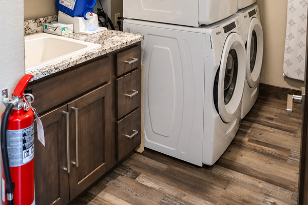 Laundry room with double stacked washers and dryers.