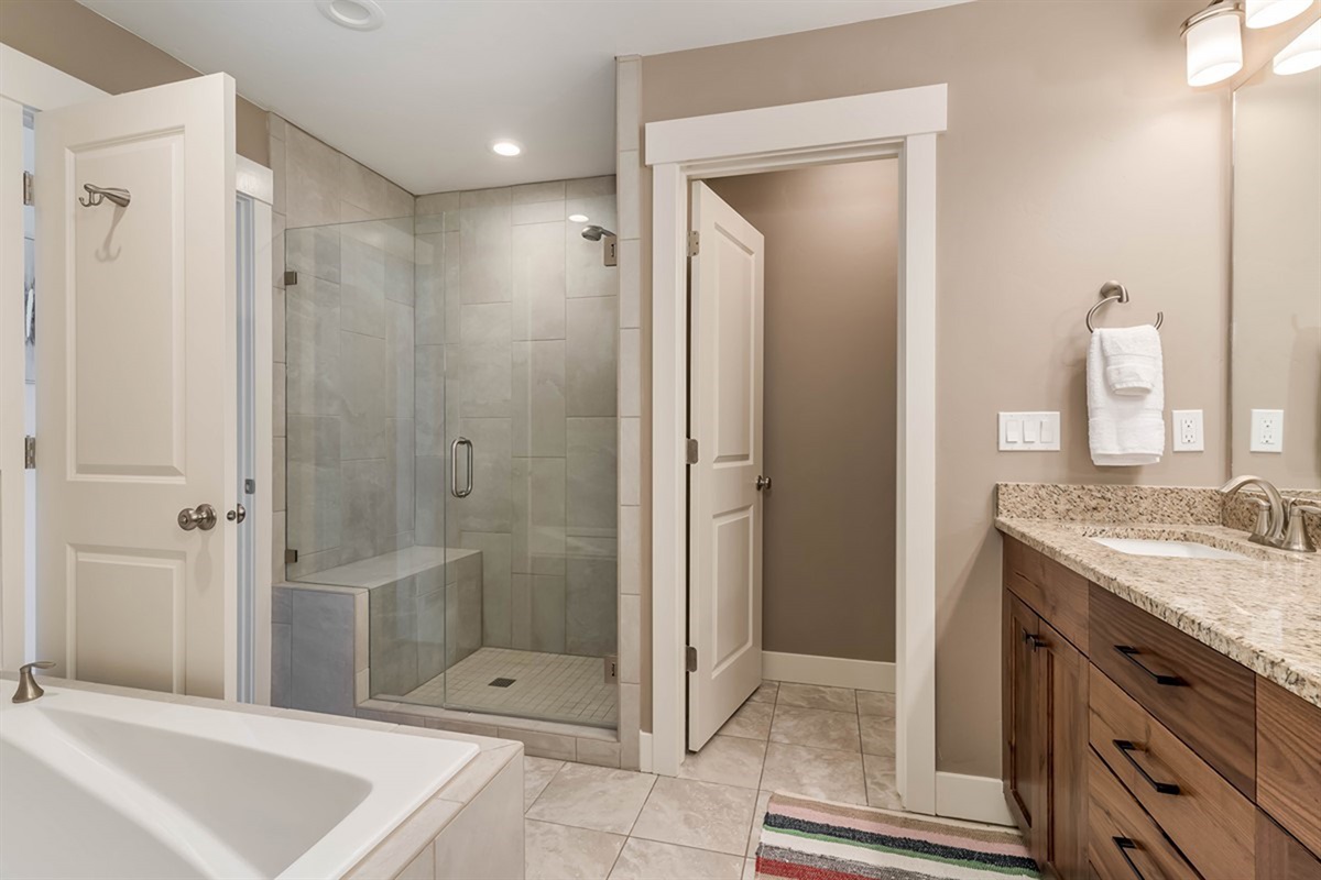 Luxurious primary bath with walk-in shower and spacious counter.