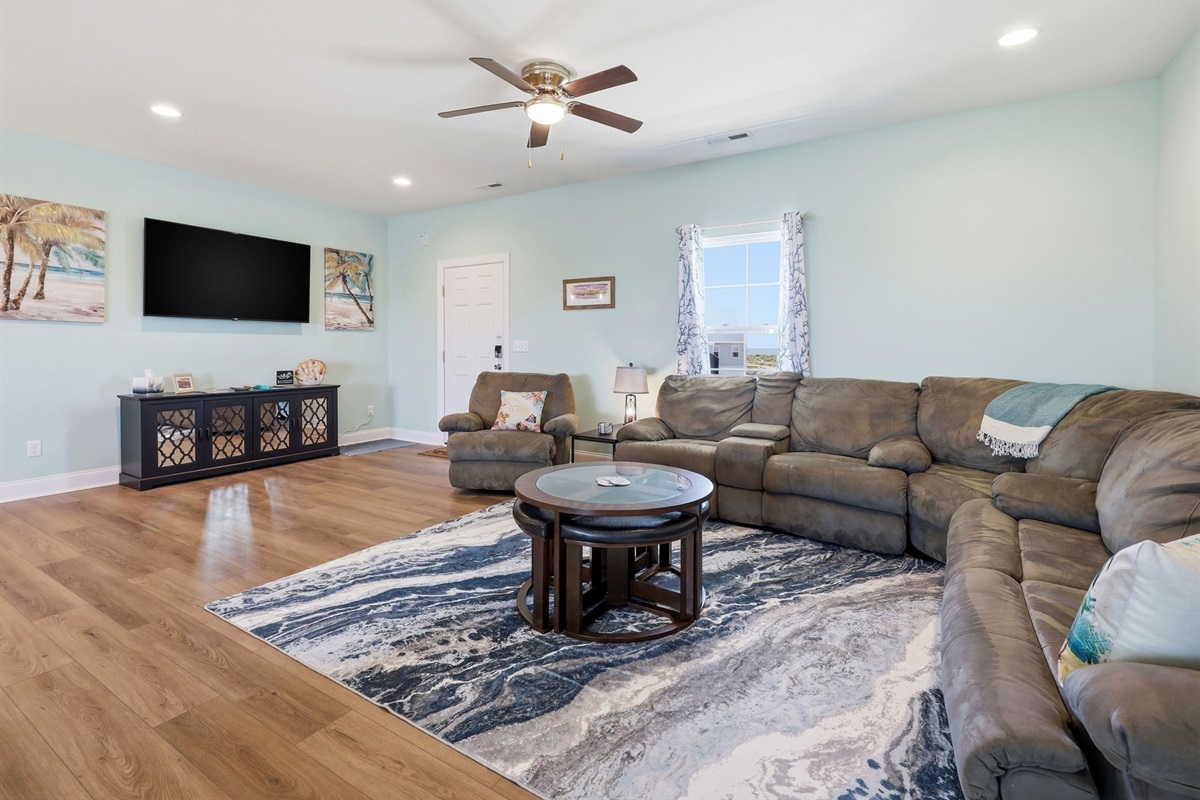 Second living area with oversized sectional and TV for movie nights