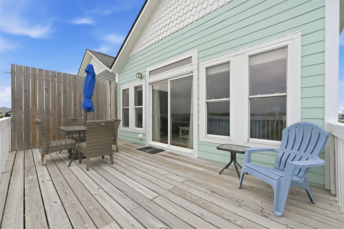 Spacious deck with sliding door access and outdoor seating
