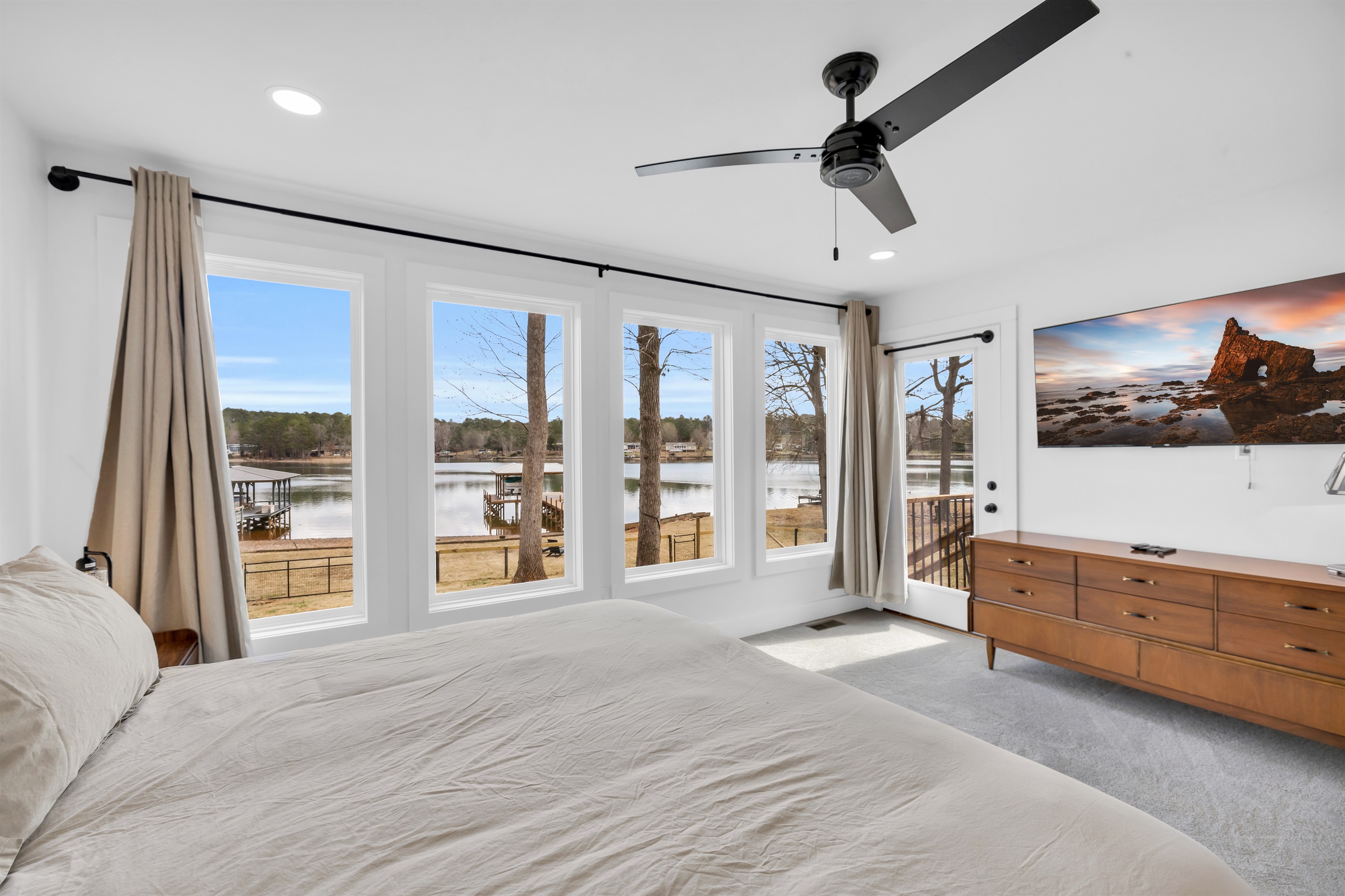 Master bedroom with king bed and a view of the lake 