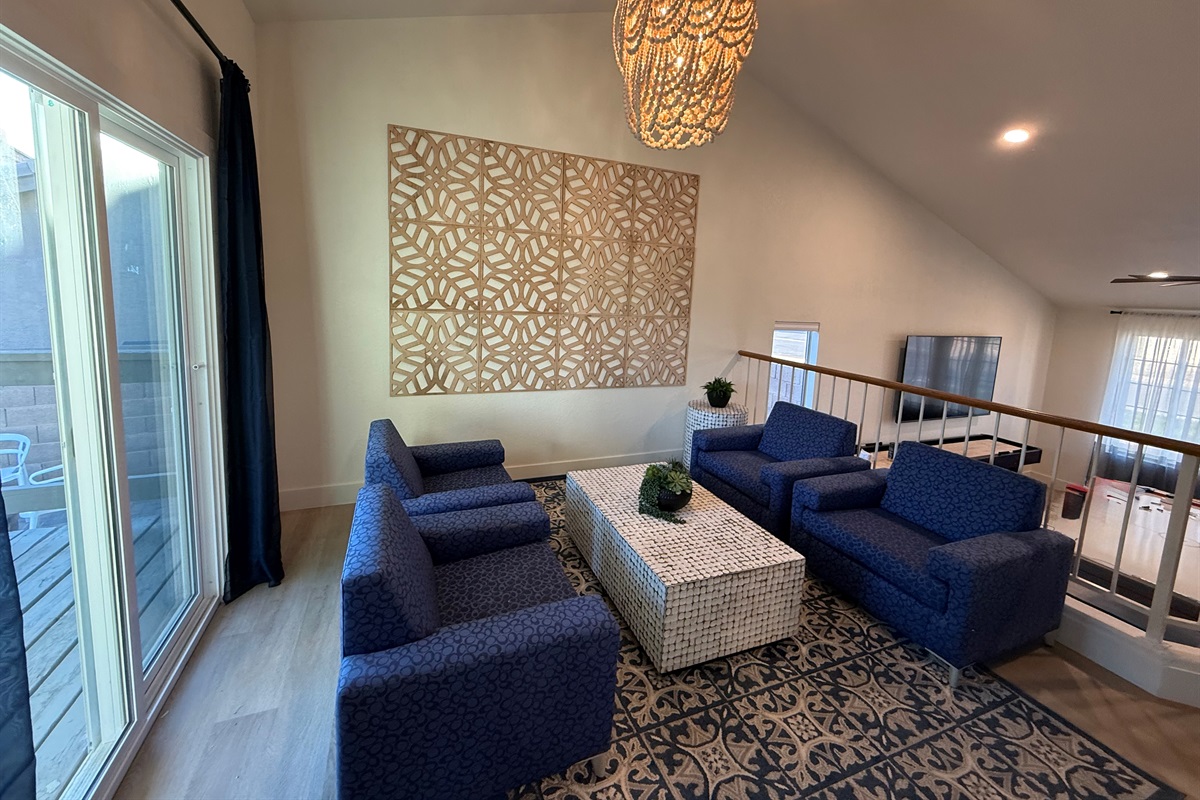 Just one of many gathering areas, this hip lounge has four arm chairs and connects to deck/balcony overlooking the pool & fire pit.