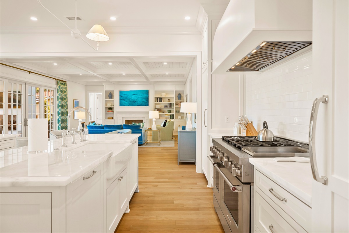 The kitchen has white cabinetry and high-end finishes.