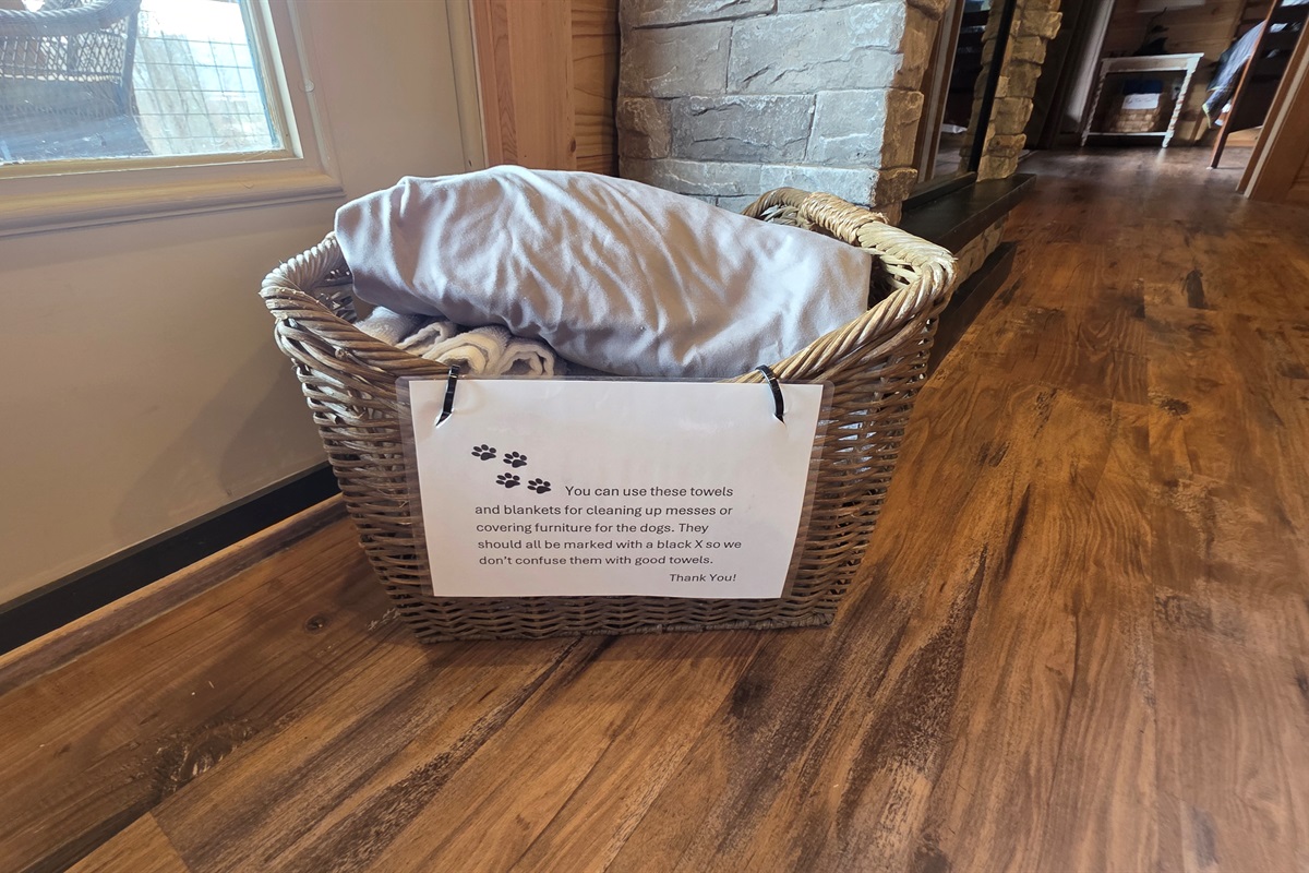 Basket of towels and sheets. These are used for messes or covering furniture for your pup.