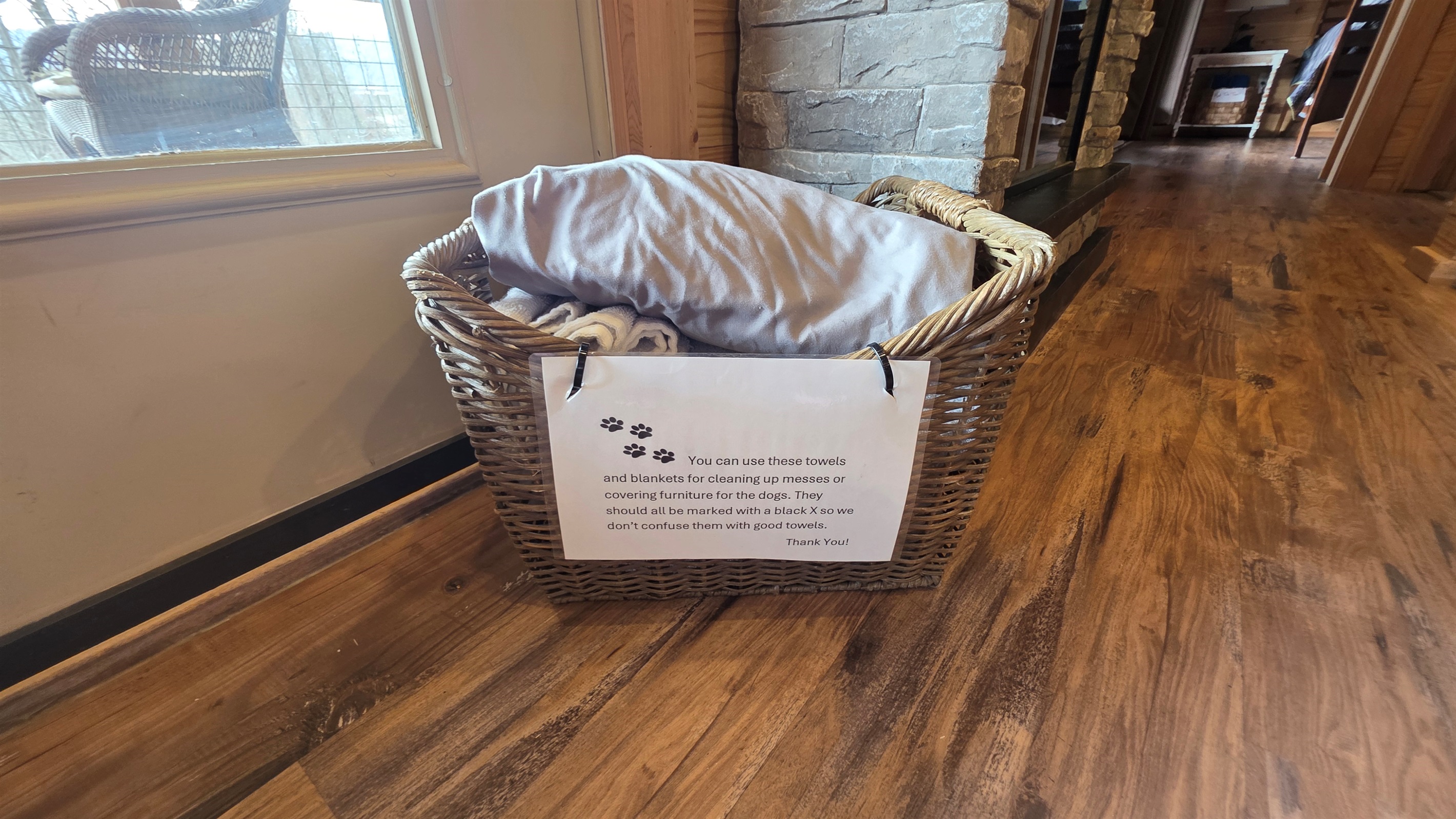 Basket of towels and sheets. These are used for messes or covering furniture for your pup.
