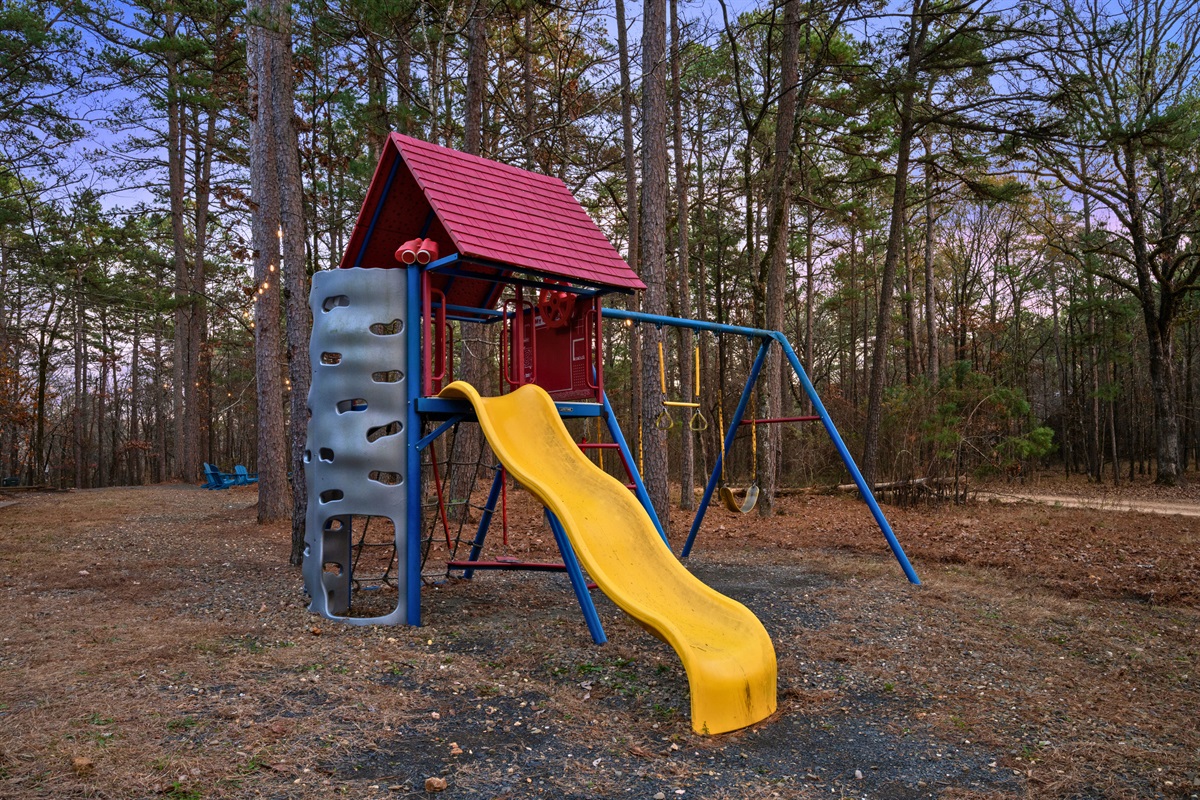 Tucked into the yard, the children’s playset offers a fun outdoor space where kids can climb, slide, and play while surrounded by nature.